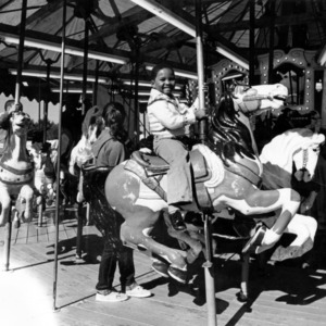 Children riding the merry-go-round at the North Carolina State Fair