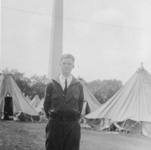 Unidentified man standing in front of Washington Monument at first National 4-H Conference, 1927