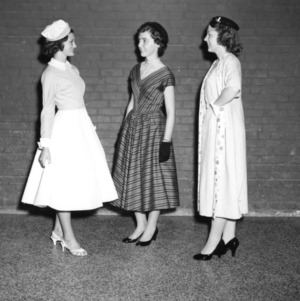 Three 4-H club members modeling their entries in the 4-H Dress Revue at Club Week held at North Carolina State College in Raleigh
