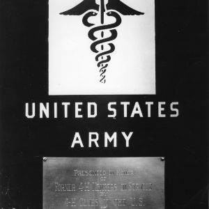 Close-up view of a plaque placed on the side of an ambulance dedicated in honor of former 4-H club members who are serving in the armed forces