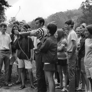 Tim Hart of Caldwell County practicing archery, surrounded by other 4-H members, at Swannanoa 4-H Camp
