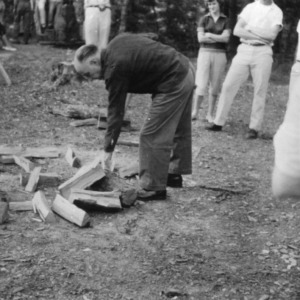 L. R. Harrill chopping wood at Swannanoa 4-H Camp