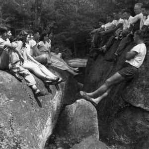 4-H club members sitting on rocks at Millstone 4-H Camp