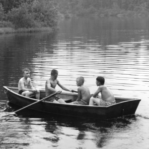 Four boys in a rowboat at 4-H Wildlife Camp, 1959