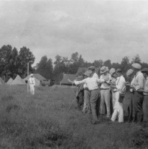 Group of men taking notes and photographs at the Davidson[-Rowan?] 4-H Camp