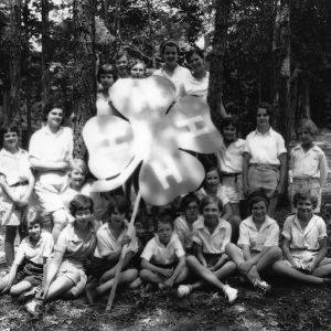 4-H club members holding a 4-H sign at the Durham County 4-H Camp in July of 1931