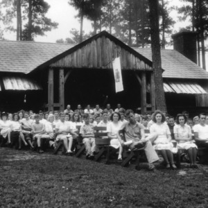 Group of participants sitting in front of building at Millstone 4-H Camp. L. R. Harrill, North Carolina State 4-H Club leader, on far right