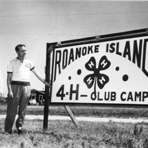 Sign at Manteo/Roanoke Island, North Carolina 4-H camp. L. R. Harrill, North Carolina State 4-H Club leader, on left