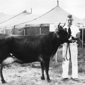 Bill Aldridge of Alamance County and his blue ribbon-winning Jersey calf at the 1931 North Carolina State Fair
