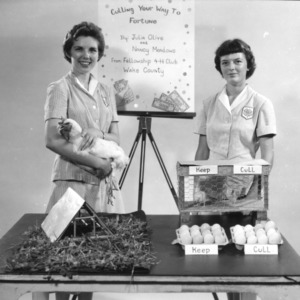 Julia Olive and Nancy Meadows, champion demonstration team in poultry production from Mt. Airy, Surrey County, North Carolina, demonstrate "Culling your way to fortune," 1956
