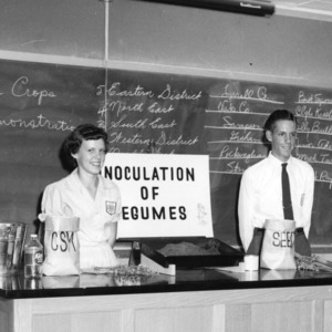 Joyce and Ray Whitley from Stanly County with winning exhibit on "Inoculation of Legumes," during North Carolina State 4-H demonstration competition, 1957