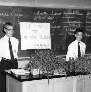 Clyde Keesler, Jr., and Charlie Fox, Jr., of Wake County with exhibit on "It Pays to Improve Pasture," during North Carolina State 4-H Demonstration Compeition, 1957