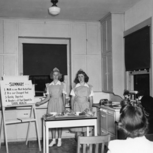 Two 4-H club girls giving a dairy foods demonstration