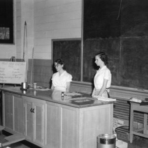 Two 4-H club girls giving a food demonstration on fruits and vegetables