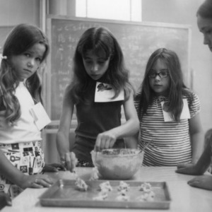 Three 4-H club girls making cookies as part of a 4-H food preparation program
