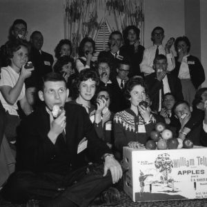 Delegates eating William Tell brand apples, grown in Waynesville, North Carolina, while attending the National 4-H Club Congress