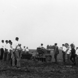 4-H club members using a tractor while attending North Carolina State 4-H Short Course at North Carolina State College