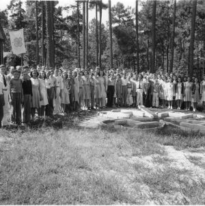 4-H club members standing around clover sculpture at North Carolina State 4-H Short Course, 1939