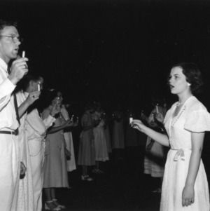 Fred Wagoner and Evelyn Waugh holding candles while attending North Carolina State 4-H Club Week