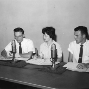 Three 4-H club members speaking into microphones at North Carolina State 4-H Club Week