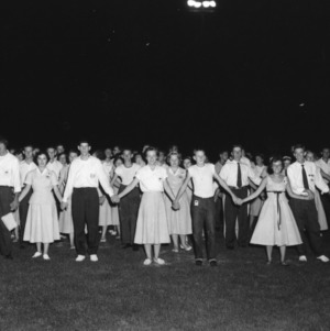 Group of 4-H club members standing in ranks and holding hands during North Carolina State 4-H Club Week