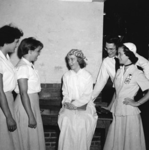 4-H club members talking to younger girl in costume, during North Carolina State 4-H Club Week