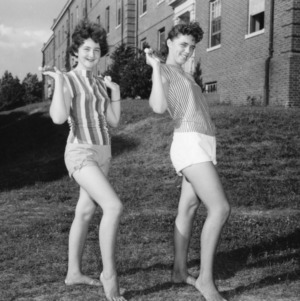Two girls posing with batons, during North Carolina State 4-H Club Week
