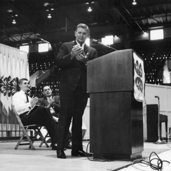 North Carolina Governor Terry Sanford holding a jar on stage at Club Week held at North Carolina State College