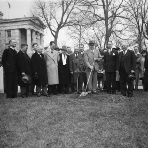 North Carolina Governor Cherry (with shovel), Dr. Hoffman, L. R. Harrill, Josephus Daniels and Frank Jeter among others planting a tree at the state capitol