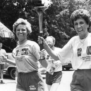 Nora Lynn Finch and Kay Yow carrying United States Olympic Festival Torch through North Carolina State University campus, fall 1987