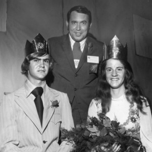 North Carolina 4-H Leader Chester Black crowning Douglas Lee and Jocelyn Sharpe as North Carolina 4-H King and Queen of Health