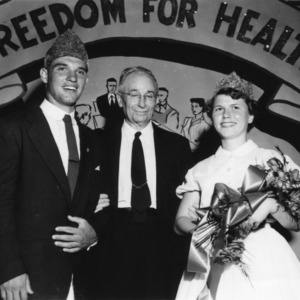 4-H king and queen of health standing with an unidentified man