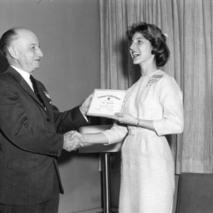 Anne Hostettler receiving a certificate from the National Safety Council presented by L. R. Harrill