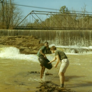 Two 4-H club boys clear tires from river, 1970