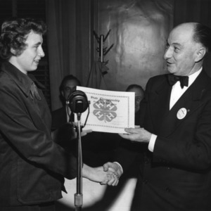 Jimmie Margaret Gilliam receives a certificate of achievement from L. R. Harrill, 1957