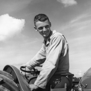 Thomas Smitherman, a 4-H club member, driving his tractor having won the prize for top tractor, July 1959