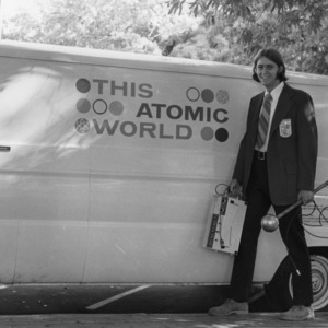 Unknown person with "This Atomic World" traveling demonstration program