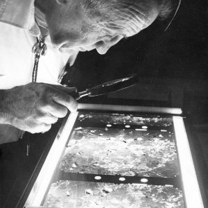 Unknown person examining aerial photographs