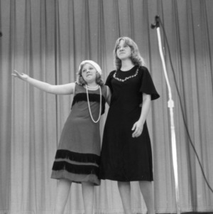 Two 4-H club members singing in costume at a statewide 4-H talent show competition