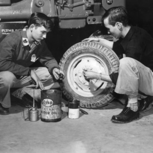 4-H club members work on a tractor tire at a 4-H tractor program