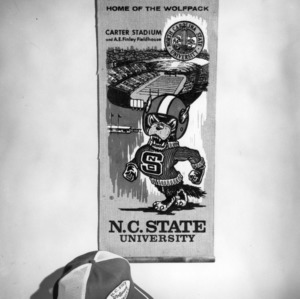 Home of the Wolfpack banner and N. C. State hat