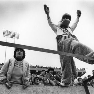 Black and white image of person (left) next to Mascot (right).