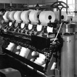 Man overseeing a textile machine in operation