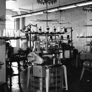 Brinton knitting machine in textile lab, probably in Tompkins Hall