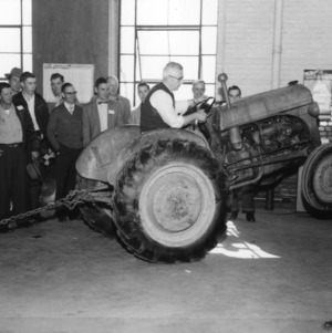 J. C. Ferguson demonstrates how not to hitch for efficient operation and safety [at a 4-H Club tractor program]