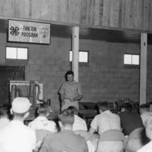 Club members listening to a lecture at a 4-H tractor program