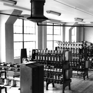 View inside a textile machine room with yarn spinning machines