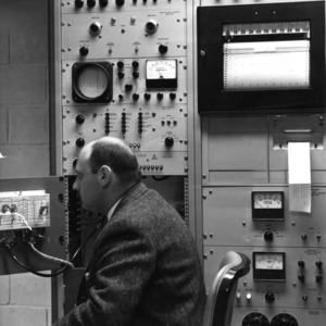 Otto Teszler, head of the textile radiation lab, working with some equipment