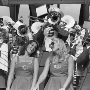Two cheerleaders with the band