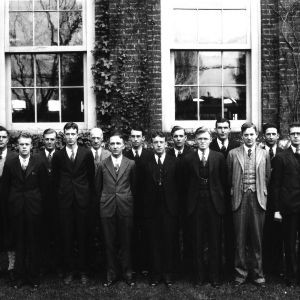 Group portrait of students and faculty in front of Tompkins Hall